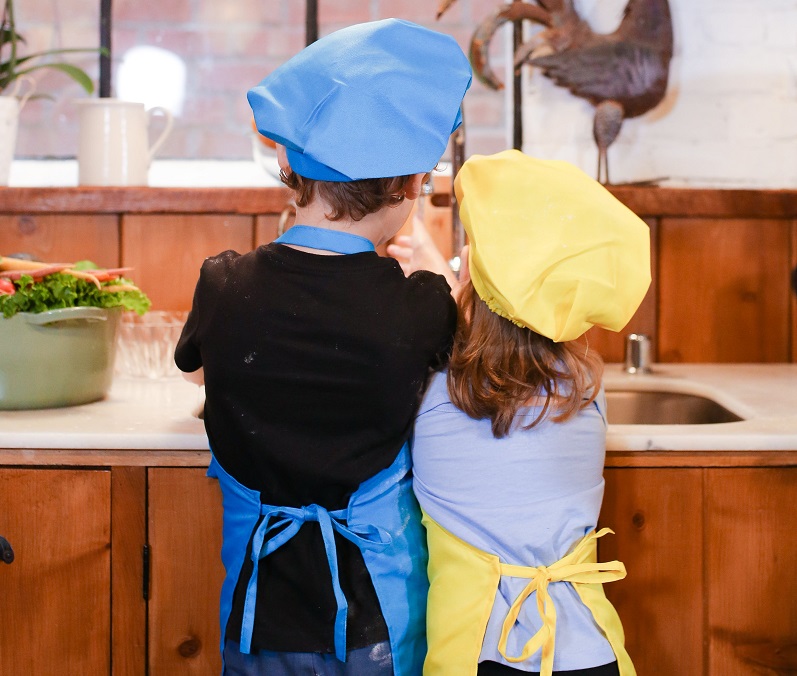 kids in chef's hats and aprons