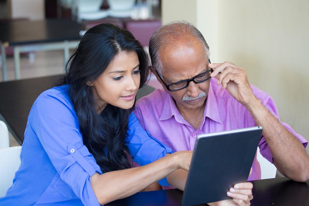 image of young woman teaching a senior technology